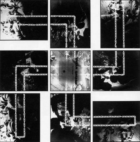 Mixed media. Nine black and white photographs show bodies nearly swallowed in shadow. The photographs are in thin black frames and laid out so they together loosely form the shape of a backwards swastika. A doubled-over white chain is superimposed on the photographs to highlight the symbol. The central photograph contains the text “Human Bondage” with further lines underneath in smaller text that cannot be read.