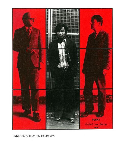 Mixed media. Nine photographs, each in a thin black frame, are arranged in a grid of three by three. The three black and white images down the centre are a portrait of a shorter man with medium dark skin. He stands with his hands in his pockets, looking out from deeply shaded eyes. The leftmost three and rightmost three columns are in red and greyscale. They each show a pale-skinned man wearing a suit looking towards the centre. The word “Paki” is in black text near the lower right corner.